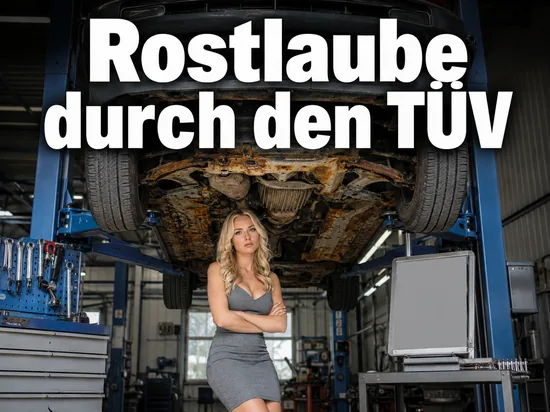Durchgerostetes Auto auf der Hebebuehne einer Pruefwerkstatt