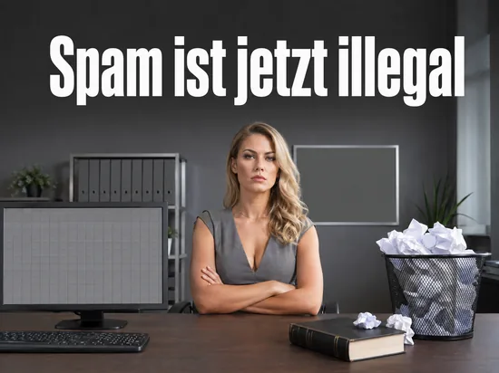 Buerotisch mit Monitor, ueberfuelltem Papierkorb und Gesetzbuch